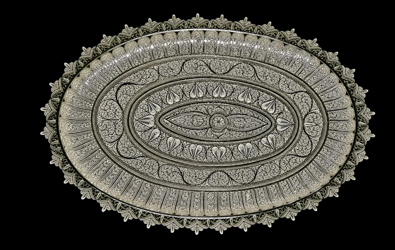Round silver serving tray bordered with repeating filigree petals