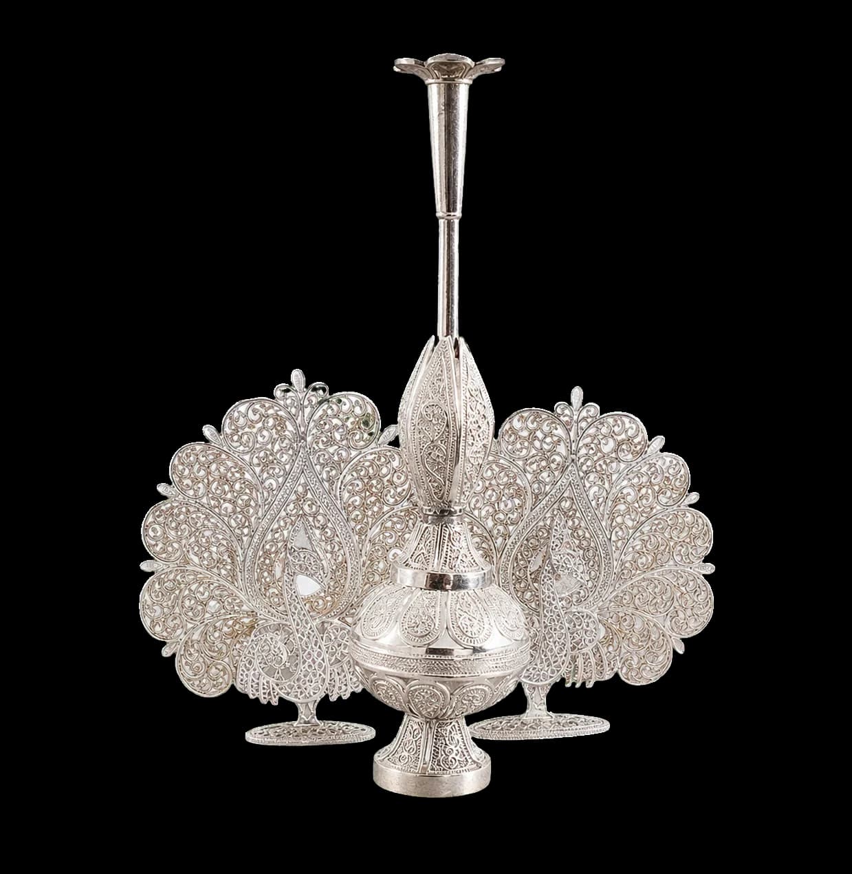 Silver filigree incense burner framed by two peacocks