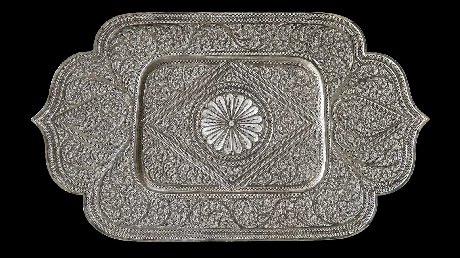 Rectangular silver serving tray filled with dense floral filigree patterns
